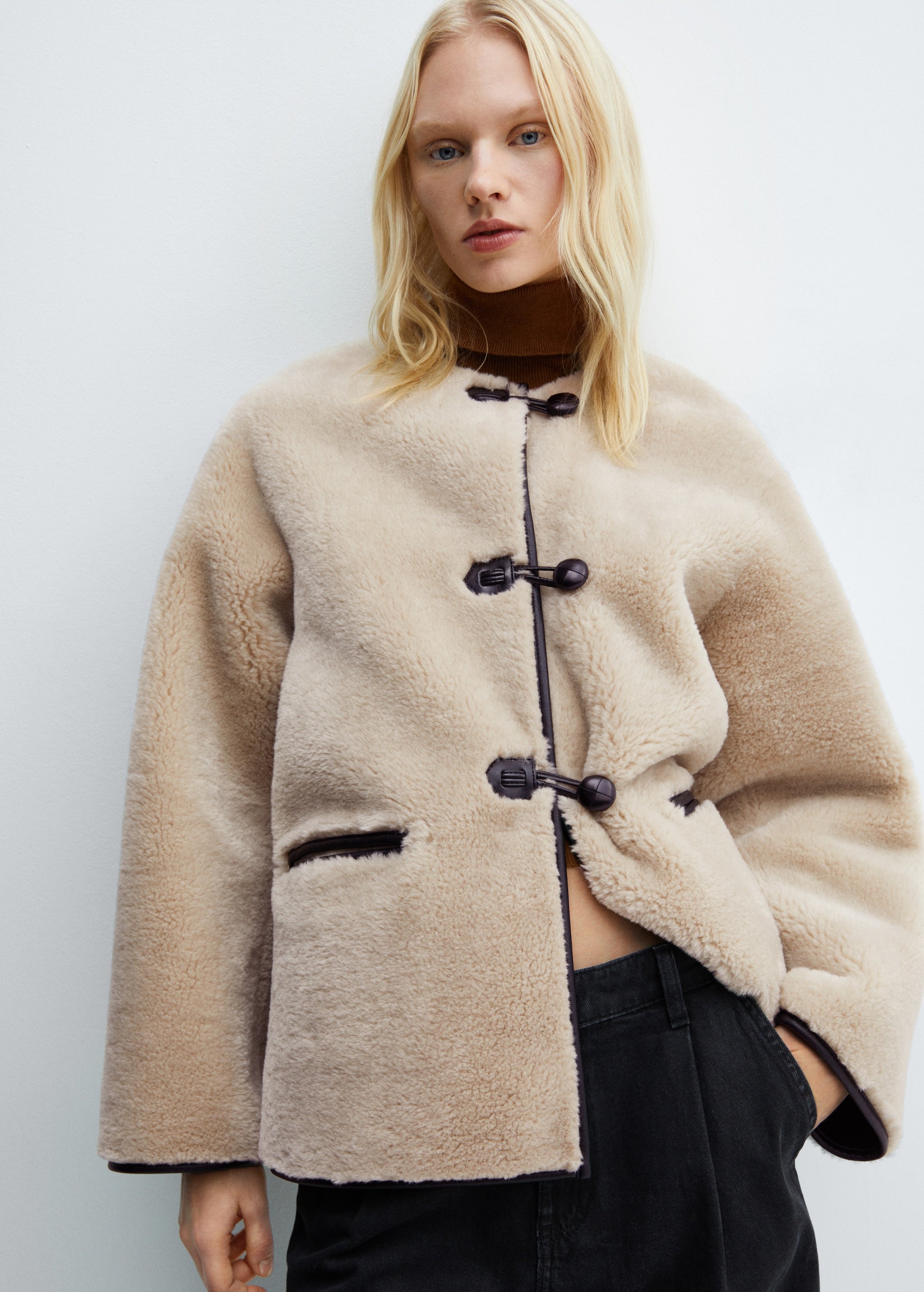 Faux fur coat with applications